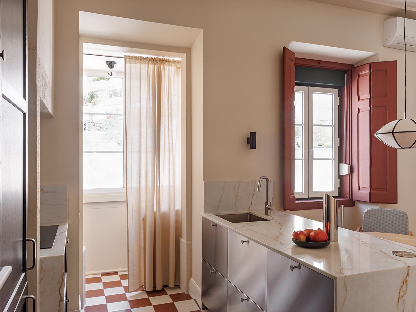 A Mirrored Island Makes This 646-Square-Foot Lisbon Apartment Feel Grand
