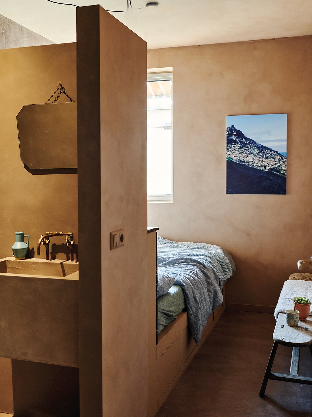 bed with bathroom wall behind it
