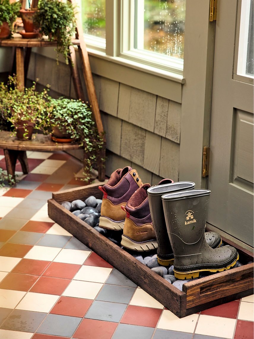 boot tray made with river rocks and boots on top
