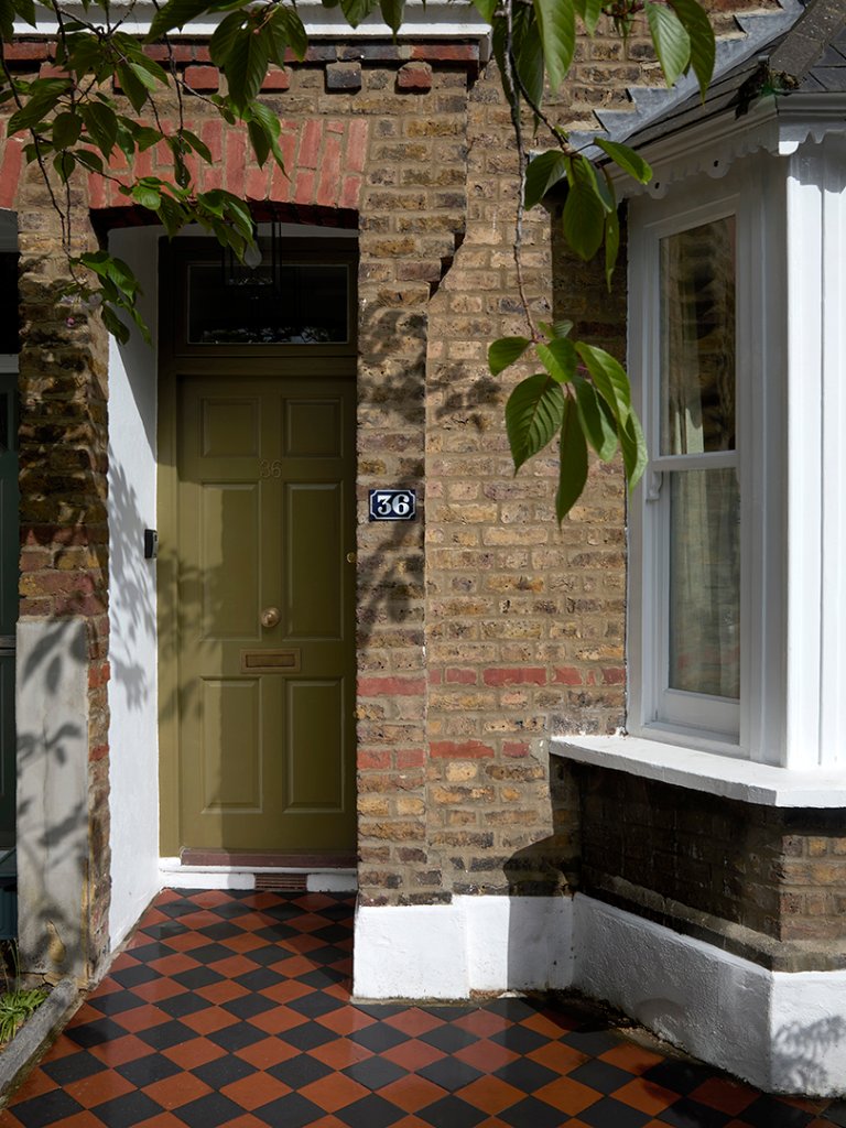 exterior with green door and checkered ground