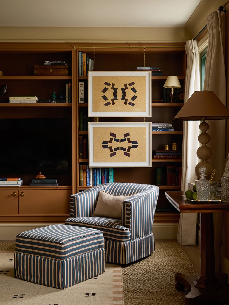 art hanging in front of bookshelves
