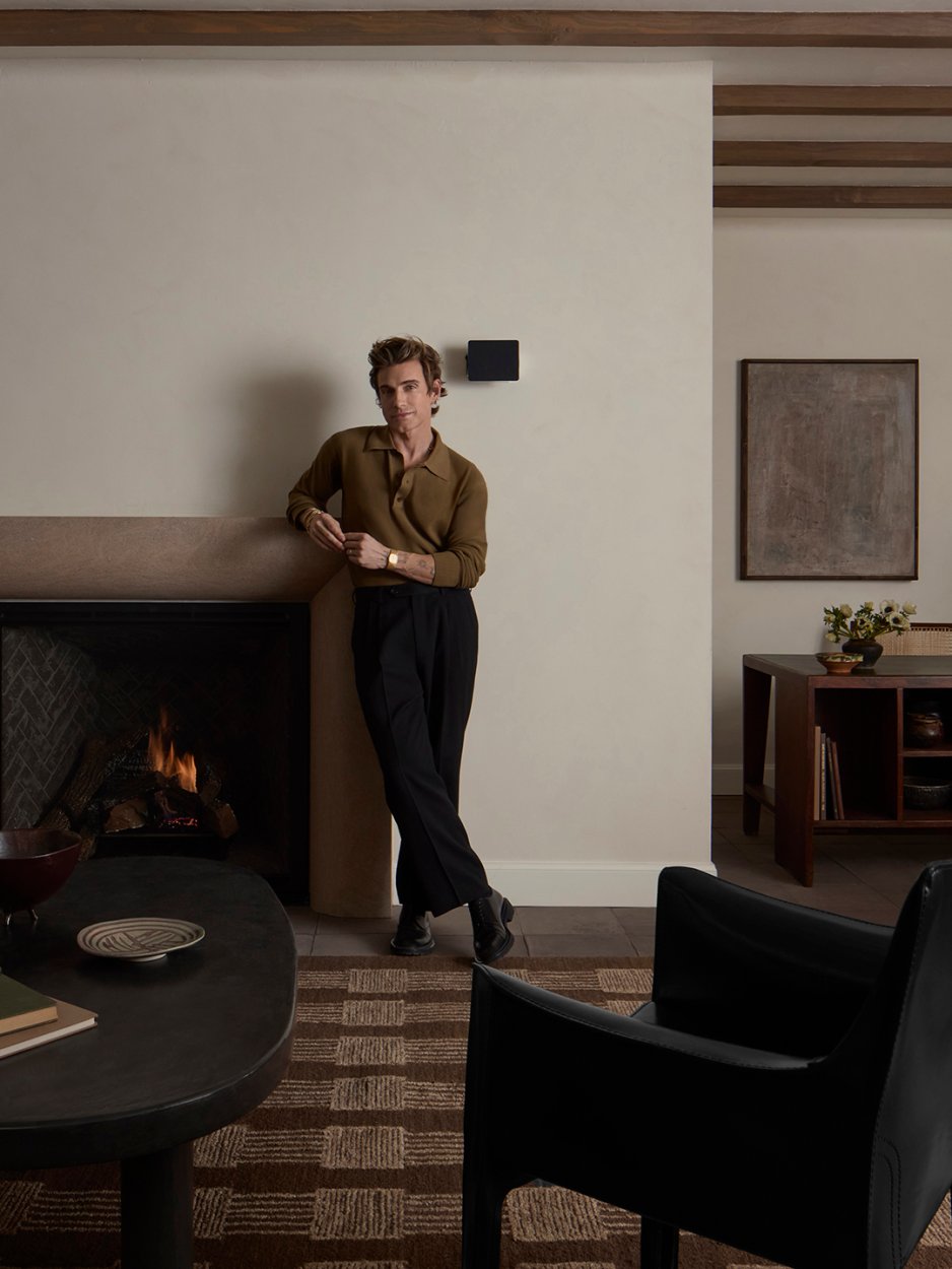 man leaning on mantel