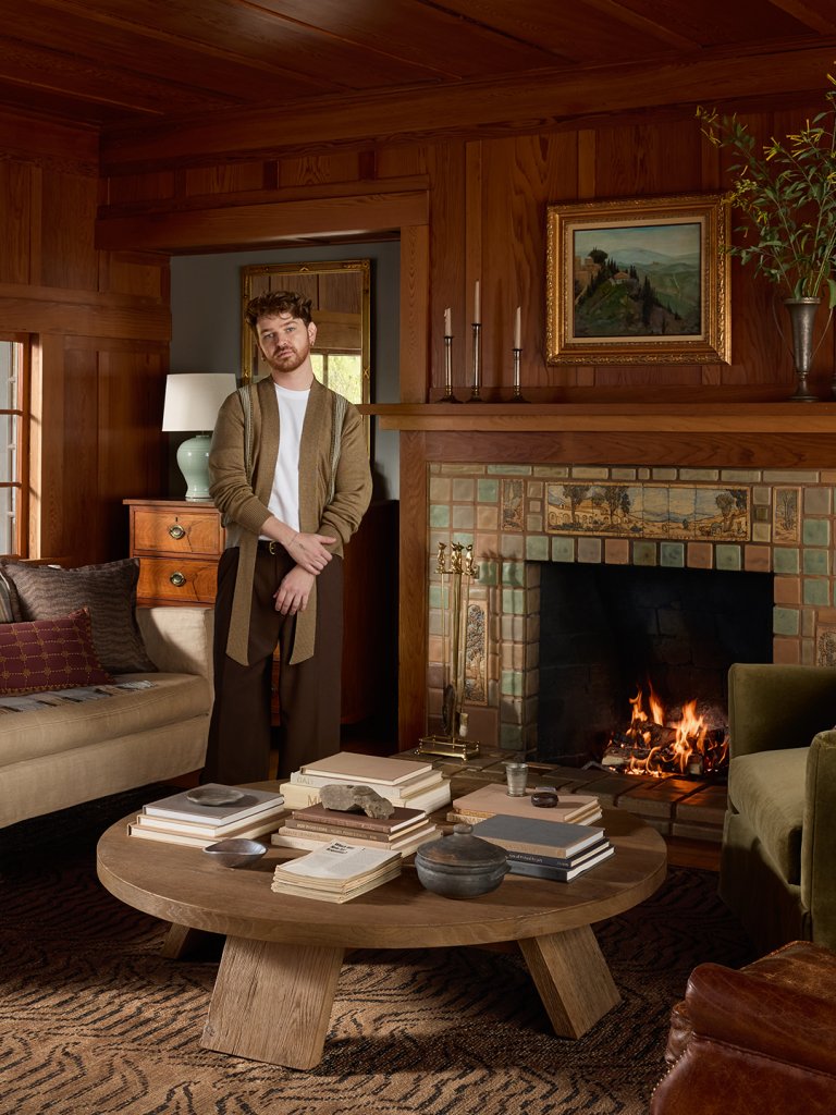 man next to fireplace
