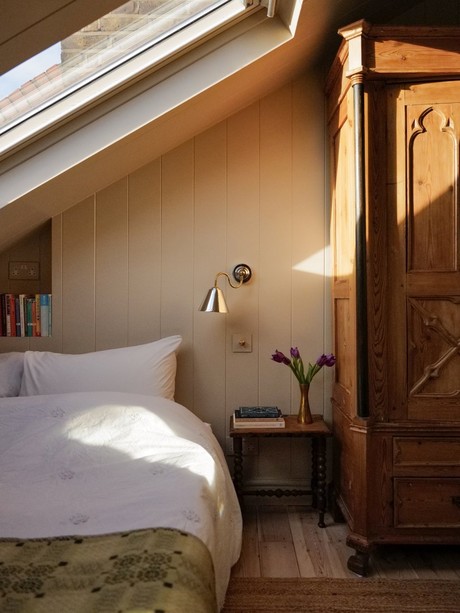bedroom with conical brass sconce