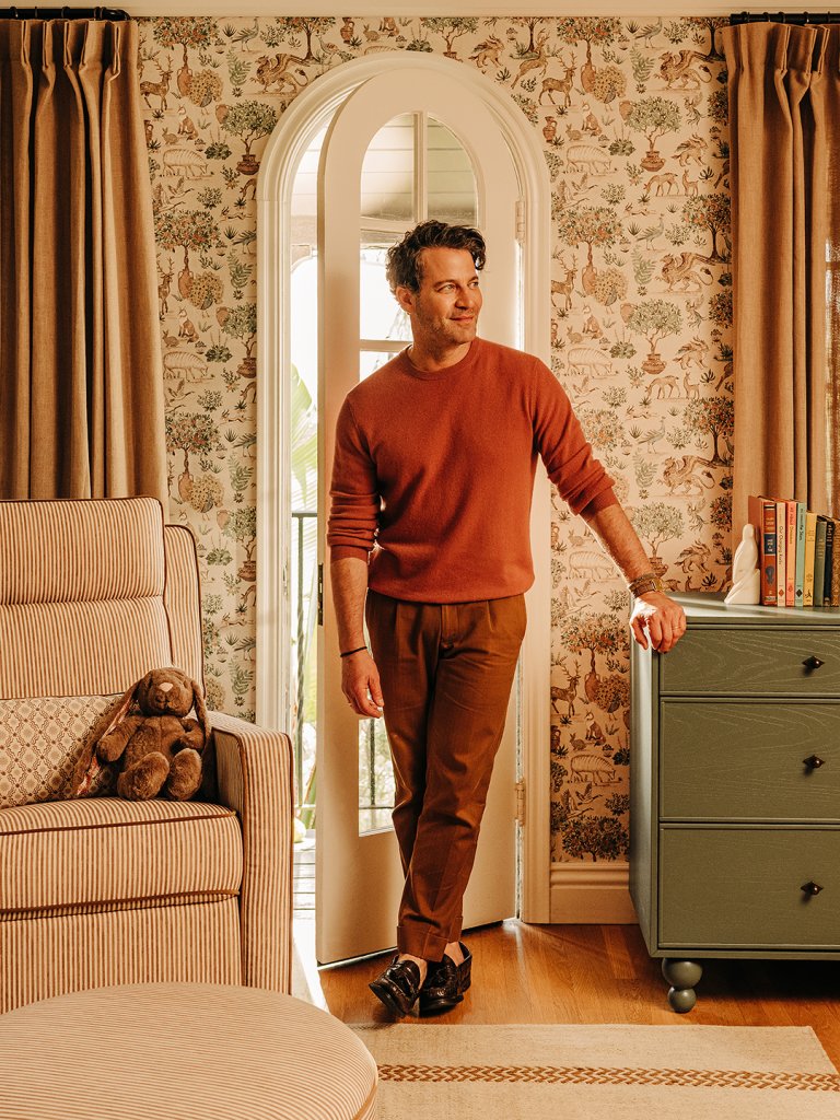 man leaning on dresser