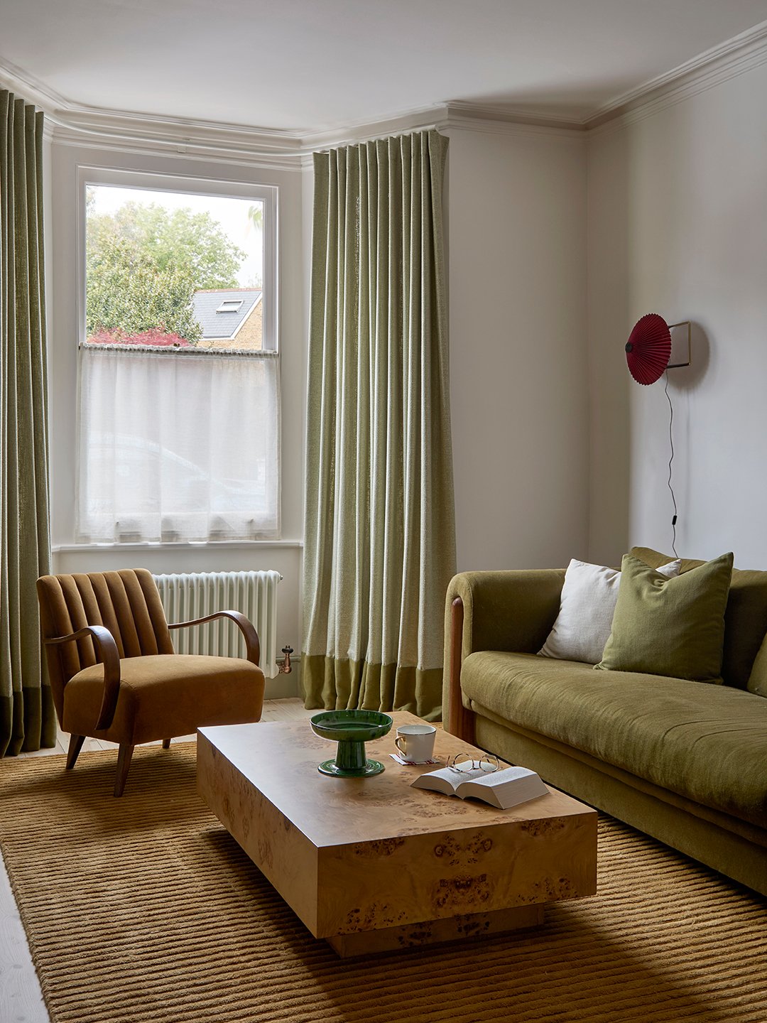 living room with green curtains and sofa