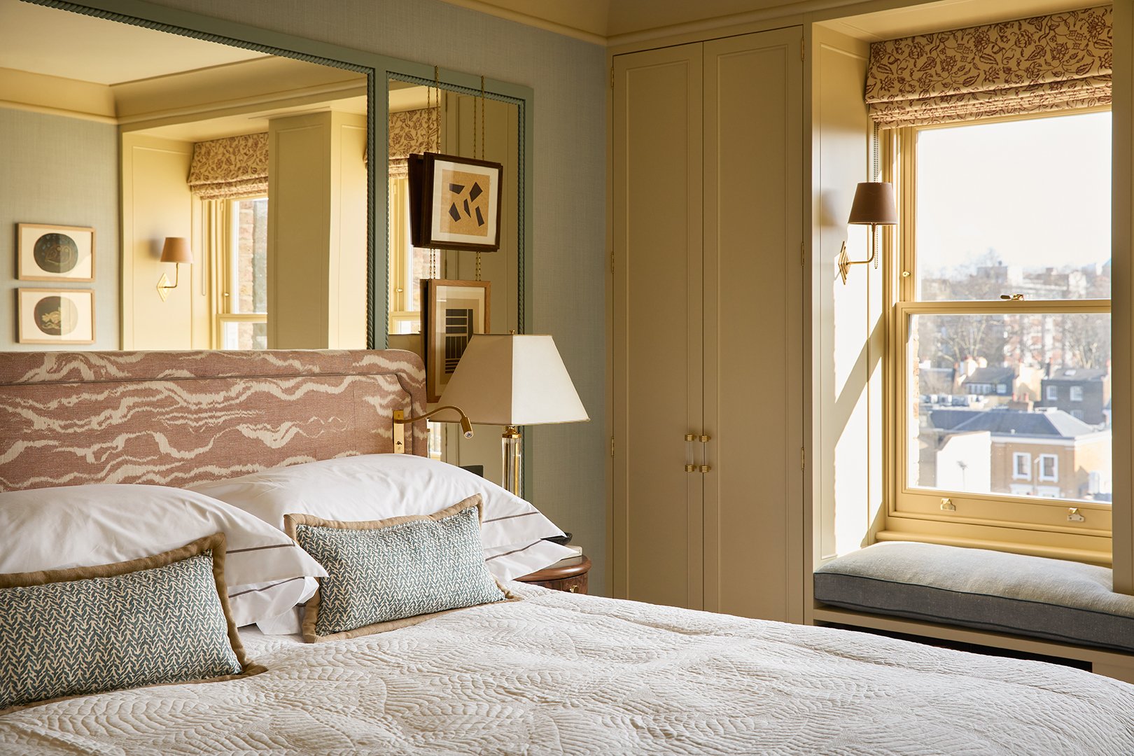 bedroom with mirror wall behind