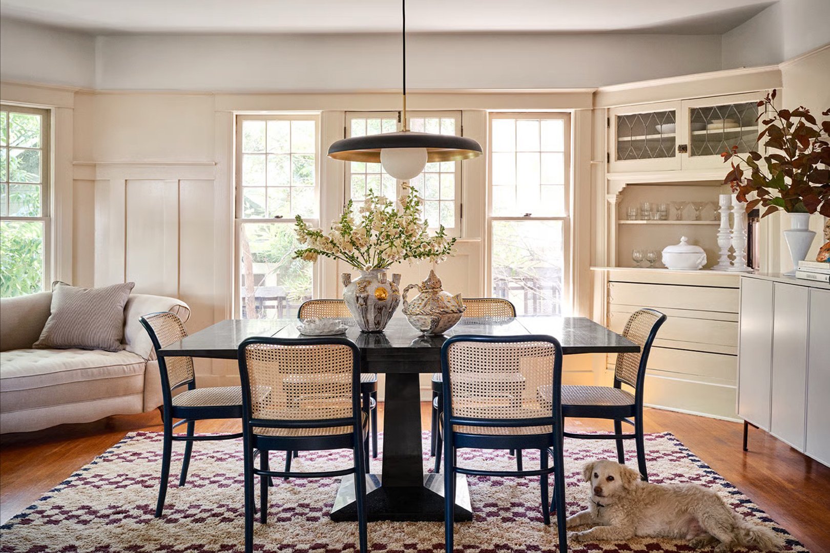 dining room with black table and dog