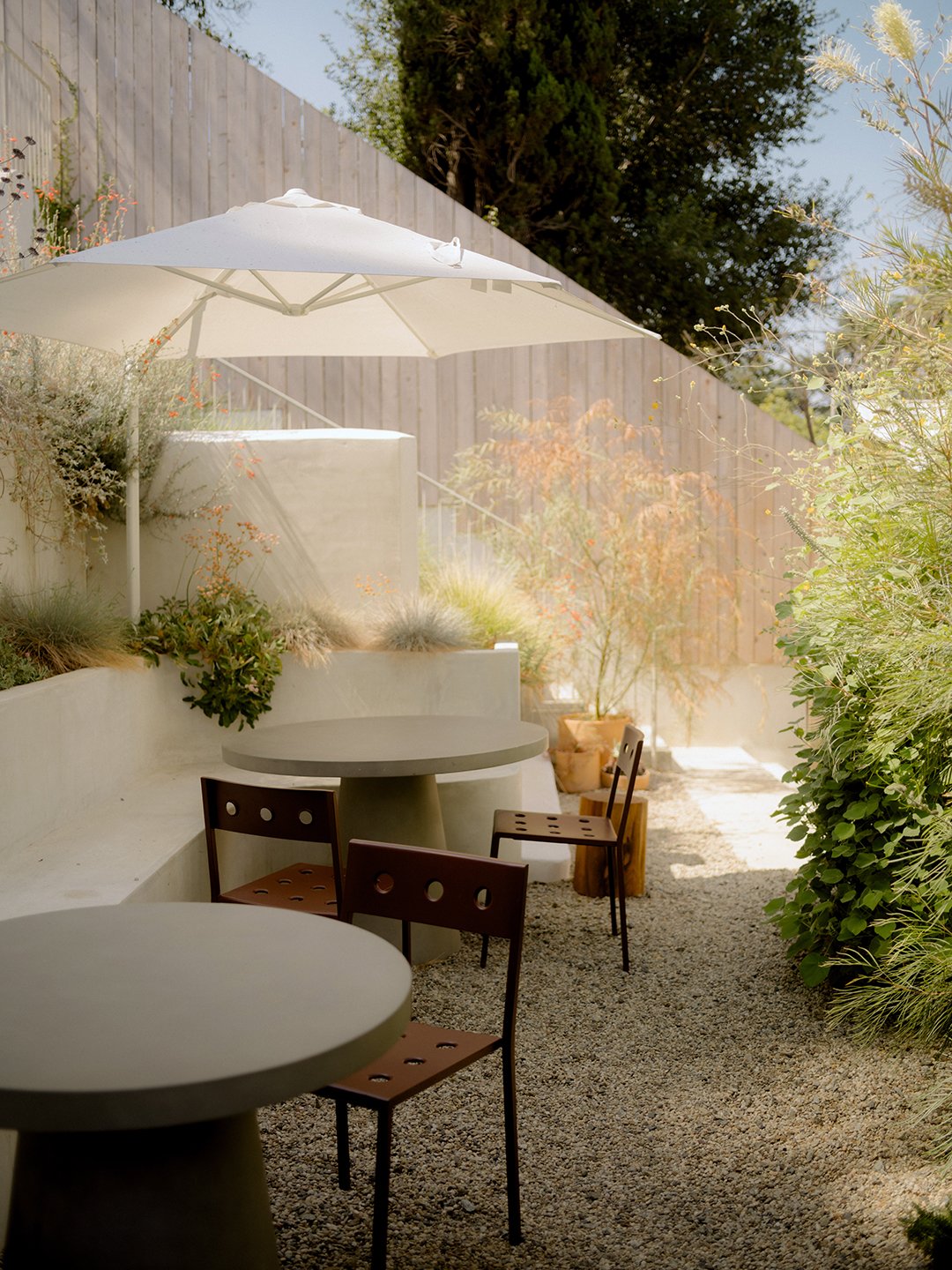 round tables at stucco bench