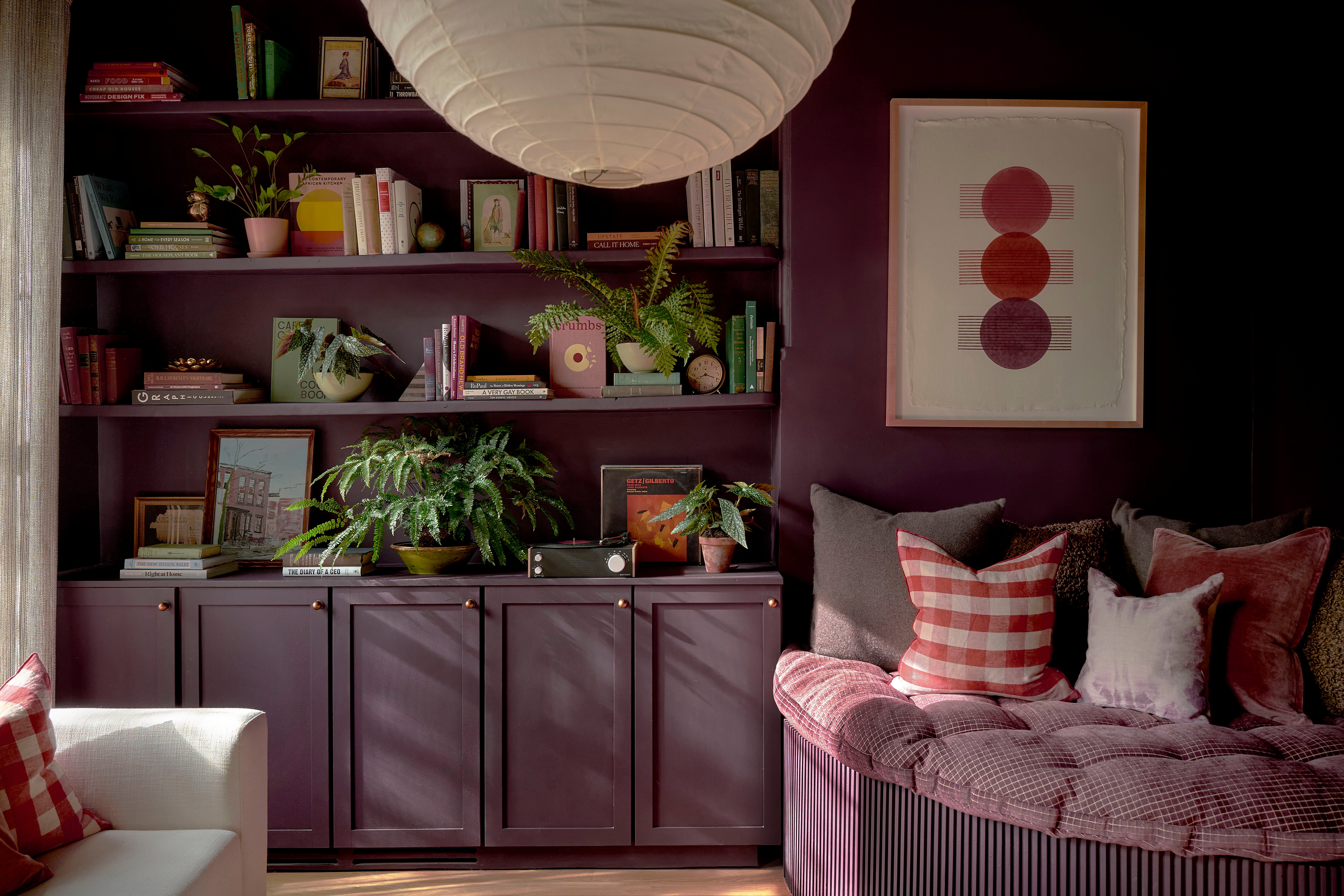 purple office with shelves and daybed