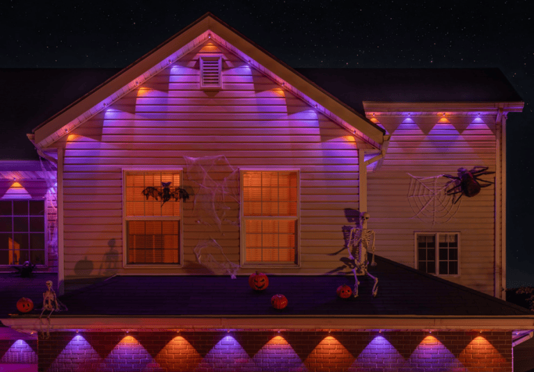Home lit up with colorful Halloween lights.